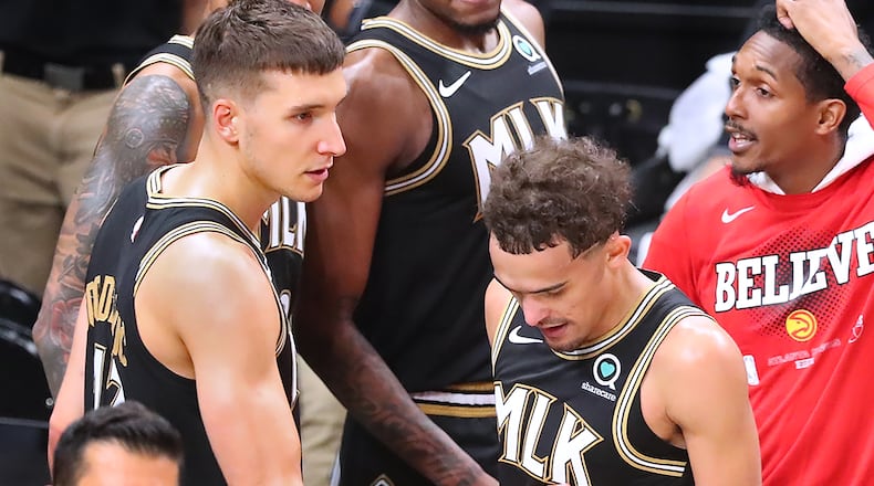 Hawks guard Bogdan Bogdanovic consoles Trae Youne as time expires with the Milwaukee Bucks winning game 6 of the NBA Eastern Conference Finals to eliminate the Hawks and advance on Saturday, July 3, 2021, in Atlanta.   “Curtis Compton / Curtis.Compton@ajc.com”