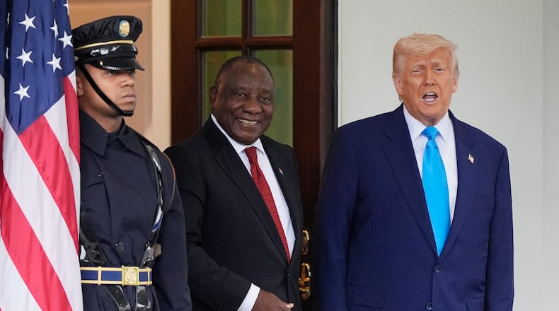 FILE - President Donald Trump greets South African President Cyril Ramaphosa, center, at the White House, May 21, 2025, in Washington. (AP Photo/Julia Demaree Nikhinson, File)