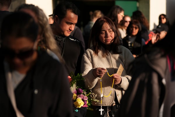 Gerard Gaba, left, and his mother Wilma Gaba, attend a vigil after a vehicle drove into a crowd during a Filipino heritage festival in Vancouver, British Columbia, Sunday, April 27, 2025. (AP Photo/Lindsey Wasson)