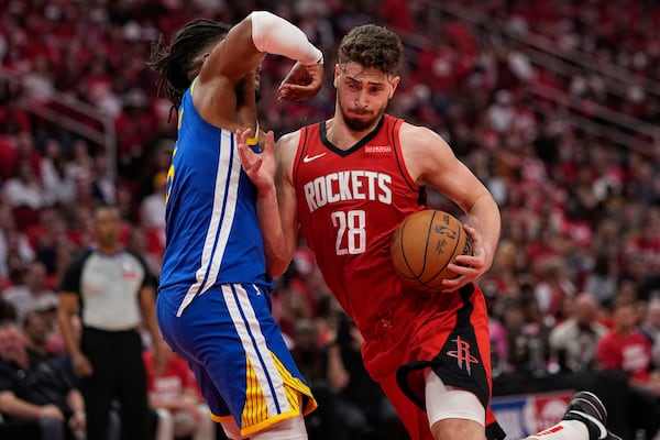 Houston Rockets center Alperen Sengun (28) shoots over Golden State Warriors forward Kevon Looney during the first half of Game 5 of an NBA basketball first-round playoff series, Wednesday, April 30, 2025, in Houston. (AP Photo/David J. Phillip)