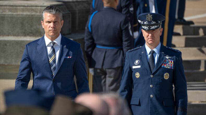Defense Secretary Pete Hegseth, left, and Chairman of the Joint Chiefs of Staff Gen. Dan Caine, right, arrive for the POW/MIA National Recognition Day Ceremony at the Pentagon, Friday, Sept. 18, 2026, in Washington. (AP Photo/Mark Schiefelbein)