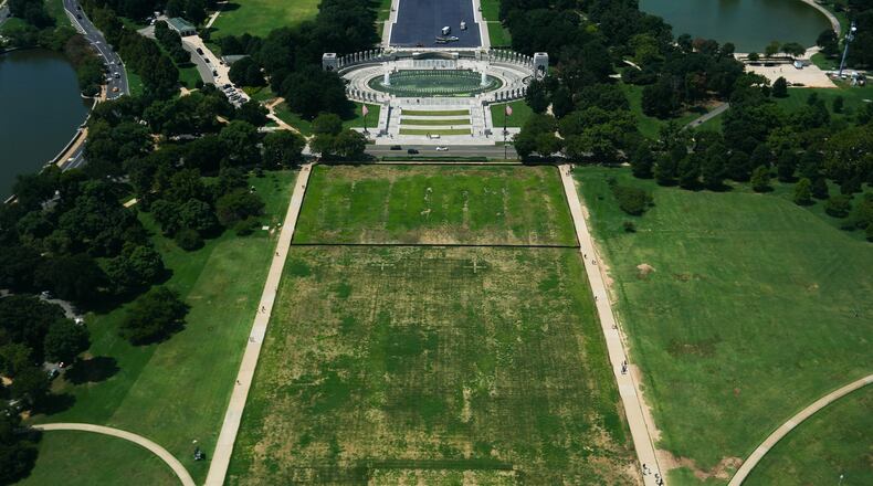 Damaged grass on the National Mall is seen from the Washington Monument, Monday, Aug. 17, 2026, in Washington, with the World War II Memorial in the background. (AP Photo/Julia Demaree Nikhinson)