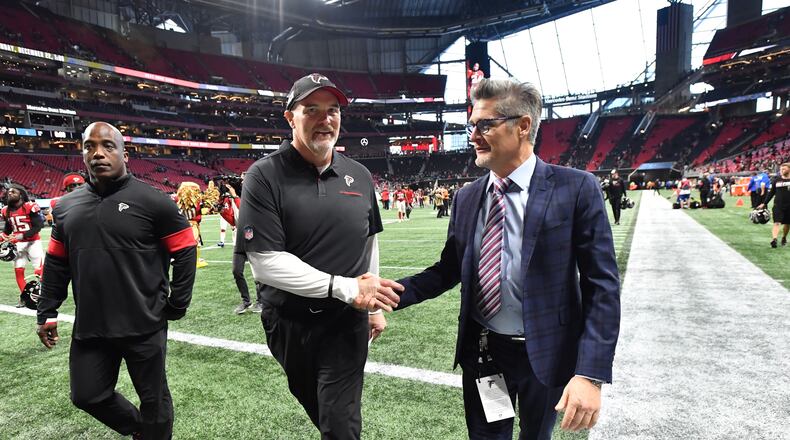 December 8, 2019 Atlanta - Atlanta Falcons general manager Thomas Dimitroff (right) congratulates coach Dan Quinn shake hands after Atlanta Falcons beat Carolina Panthers during the second half in a NFL football game at Mercedes-Benz Stadium on Sunday, December 8, 2019. Atlanta Falcons won 40-20 over the Carolina Panthers. (Hyosub Shin / Hyosub.Shin@ajc.com)