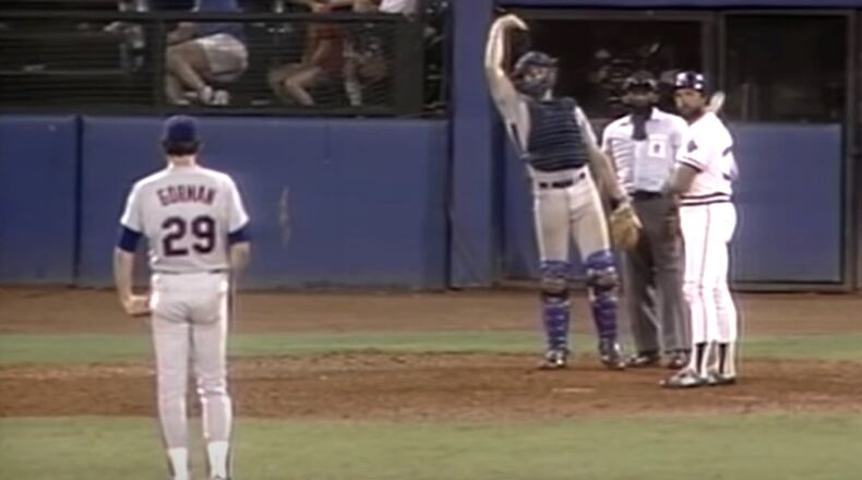 Mets catcher Gary Carter waves in his team’s outfielders just before Braves relief pitcher Rick Camp hits an 18th-inning home run in a legendary 1985 game.