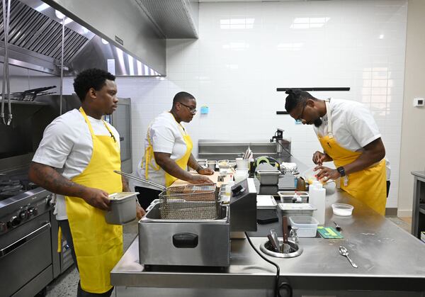 Chef Demetrius Brown, right, prepares Crudo from Haiti at Heritage Supper Club on Friday, Sept. 4, 2026, in Atlanta. Heritage, Brown’s highly anticipated new restaurant, is set to open Sept. 10. (Hyosub Shin/AJC)