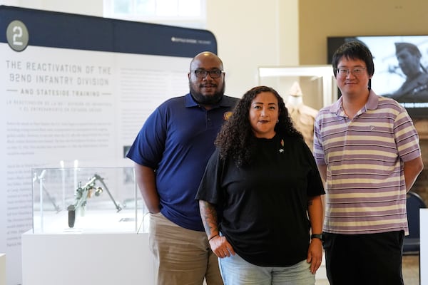 From left, Director of Exhibitions Cale Carter II, Director of Education Dr. Michelle Tovar, and archivist Jason Fung pose for a photo inside the Buffalo Soldiers National Museum on Friday, June 27, 2025, in Houston, Texas. (AP Photo/Ashley Landis)