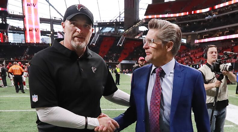 Falcons general manager Thomas Dimitroff congratulates head coach Dan Quinn on a 40-14 victory over the Cardinals in a NFL football game on Sunday, Dec 16, 2018, in Atlanta. Curtis Compton/ccompton@ajc.com