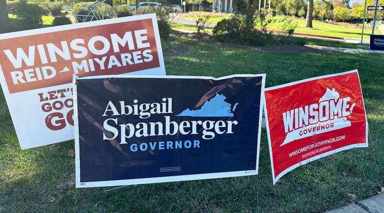Campaign signs for Virginia gubernatorial nominees Democrat Abigail Spanberger and Republican Winsome Earle-Sears are on display outside City Hall in Fairfax, Va., Friday, Oct. 17, 2025. (AP Photo/Robert Yoon)