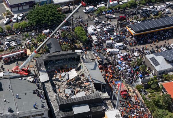 Rescue workers search for survivors at the Jet Set nightclub after its roof collapsed during a merengue concert in Santo Domingo, Dominican Republic, Tuesday, April 8, 2025. (AP Photo/Eddy Vittini)