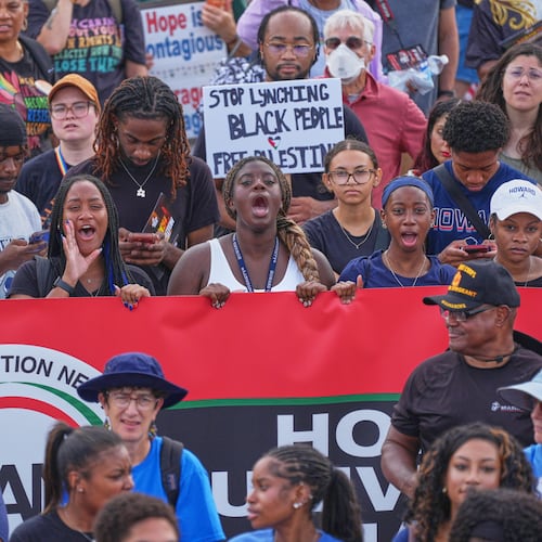 Demonstrators shout to speakers during the March on Washington, near the Lincoln Memorial, Friday, Aug. 28, 2026, in Washington. (AP Photo/Mariam Zuhaib)