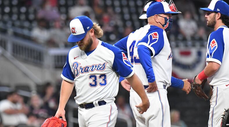 Braves relief pitcher A.J. Minter (33) is relieved in the eighth inning after issuing three walks Monday, April 12, 2021, against the Miami Marlins at Truist Park in Atlanta. The Marlins won 5-3 in an extra inning. (Hyosub Shin / Hyosub.Shin@ajc.com)