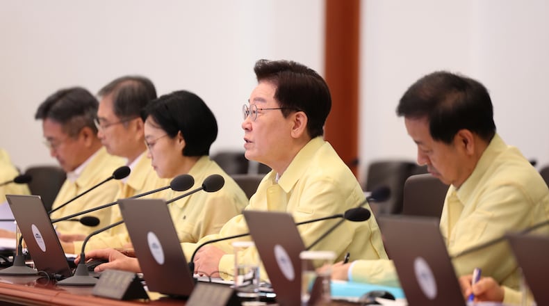 South Korean President Lee Jae-myung, second from right, speaks during a cabinet meeting at the presidential office in Seoul, South Korea, Tuesday, Aug. 18, 2026. (Yonhap via AP)