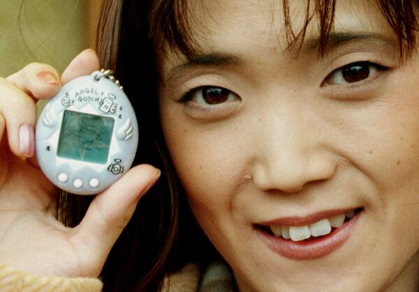 FILE - Aki Maita, Japanese developer of the Tamagotchi digital pet, shows on Monday, December 15, 1997 the new product AngelGotchi after a press conference in Hamburg, Germany. (AP Photo/Oliver Fantitsch, file)