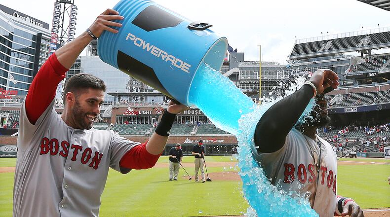 Boston’s Brandon Phillips gets dunked after hitting a 2-run homer to beat the Braves on Wednesday.