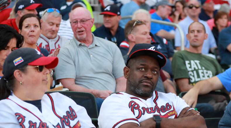 Braves fans react in shock after the Braves allowed 11 runs in the first two innings. Curtis Compton/ccompton@ajc.com