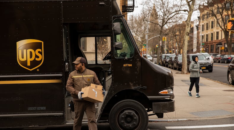 FILE -- A UPS driver makes the rounds in Brooklyn's Park Slope neighborhood, March 18, 2020. UPS announced in November that it will allow workers to have facial hair and natural Black hairstyles like Afros and braids,  becomes the latest company to shed policies widely criticized as discriminatory. (Benjamin Norman/The New York Times)