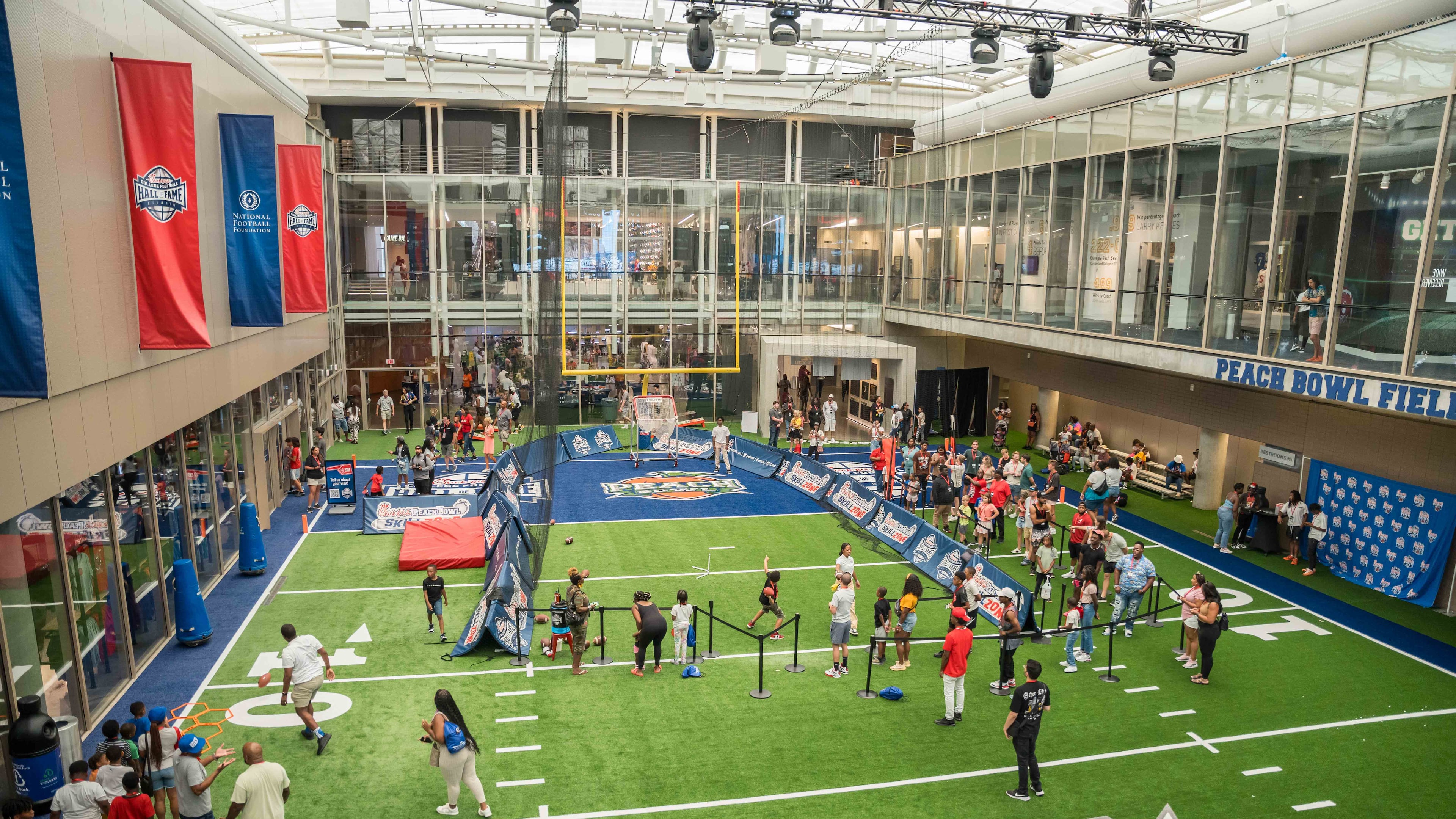 The 45-foot field at the heart of the College Football Hall of Fame gives guests the opportunity to kick field goals, throw passes and time their sprints. A jumbotron overhead will broadcast the college football kickoff games. (Courtesy/College Football Hall of Fame)