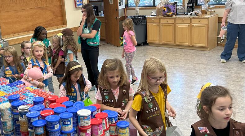 Girl Scout Brownie troops assemble almost 250 birthday bags with frosting and cake mixes to donate to food pantries and other nonprofits. Scouts learned that some children don't get cake on their birthday because of food insecurity. Courtesy of Girl Scout Troop 23134