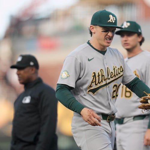 Athletics second baseman Zack Gelof, left, reacts as he walks off the field during the second inning of a baseball game against the San Francisco Giants Tuesday, June 23, 2026, in San Francisco. (AP Photo/Jeff Chiu)