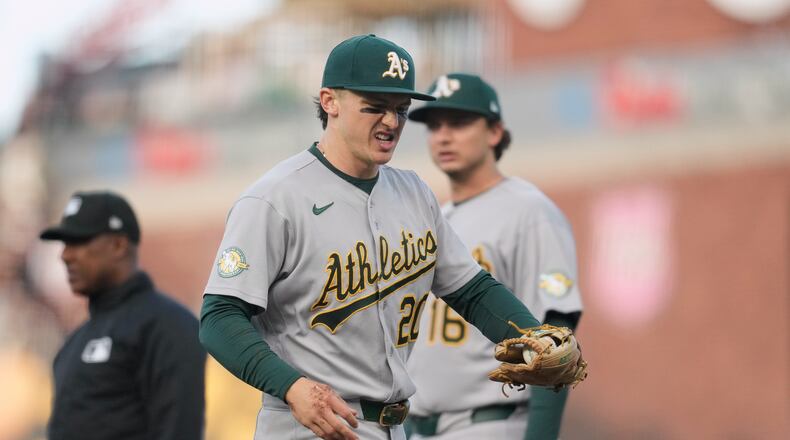 Athletics second baseman Zack Gelof, left, reacts as he walks off the field during the second inning of a baseball game against the San Francisco Giants Tuesday, June 23, 2026, in San Francisco. (AP Photo/Jeff Chiu)