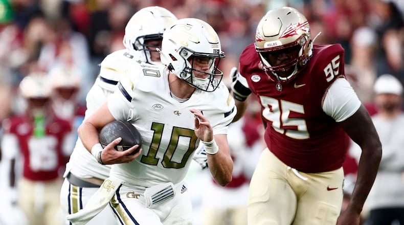 Georgia's Haynes King, left, and Florida's Daniel Lyons challenge for the ball during the NCAA college football game between Georgia Tech and Florida State at the Aviva stadium in Dublin, Saturday, Aug. 24, 2024. (AP Photo/Peter Morrison)