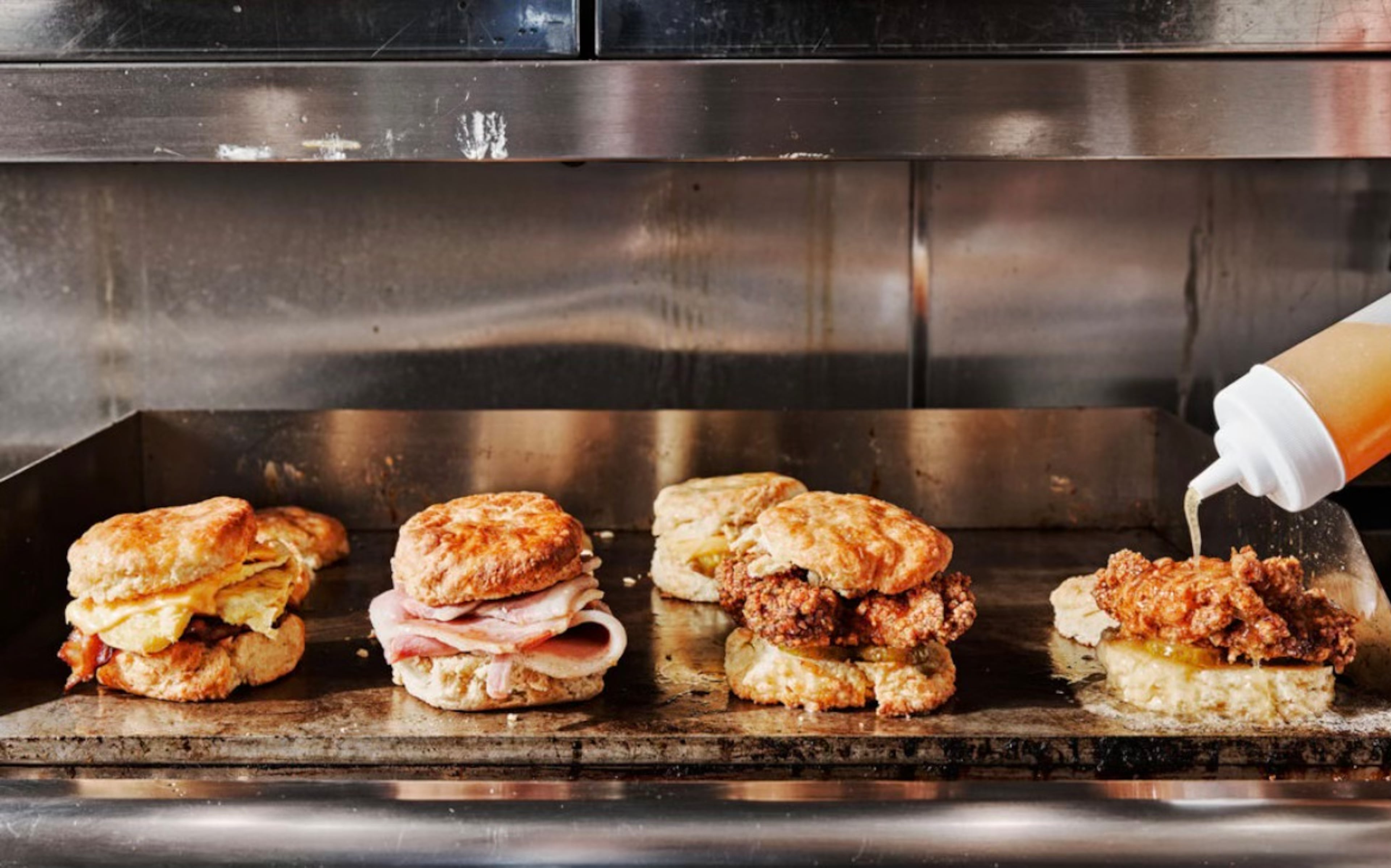 A variety of biscuits offered on Bomb Biscuit Co.'s menu are prepared on a griddle. (Andrew Thomas Lee/Courtesy of Bomb Biscuit)