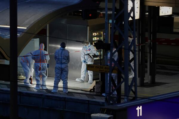 Investigators work at Hamburg, Germany's Central Station on Friday, May 23, 2025, after several people were injured in a knife attack. (Georg Wendt/dpa via AP)