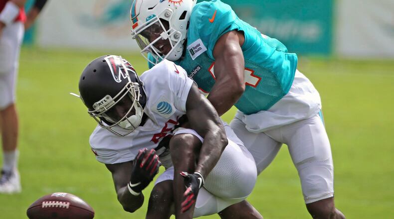 Dolphins cornerback Byron Jones (rear) and Falcons wide receiver Juwan Green run a drill during a joint training camp practice at the Dolphins training facility Wednesday, Aug. 18, 2021, in Miami Gardens, Fla.  (Charles Trainor Jr./Miami Herald)