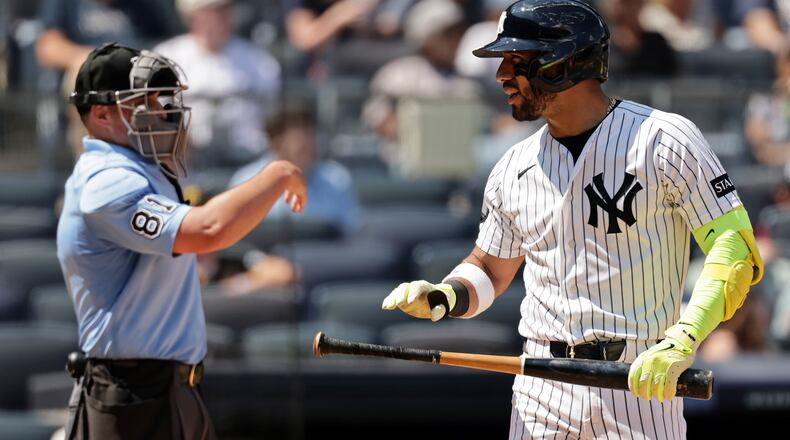 New York Yankees' José Caballero reacts after striking out in front of home plate umpire Quinn Wolcott (81) in the sixth inning during the first baseball game of a doubleheader against the Pittsburgh Pirates, Wednesday, July 22, 2026, in New York. (AP Photo/Adam Hunger)