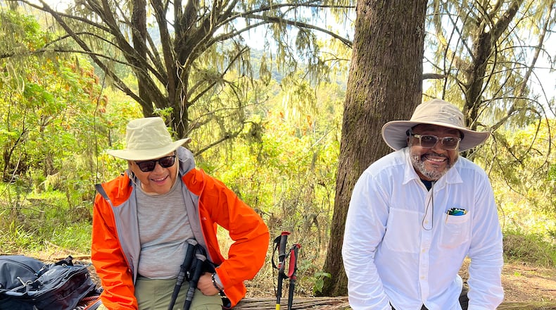 Dr David A. Thomas and C. David Moody take a breather before continuing their hike up Mount Kilimanjaro, which stands at more than 19,000 feet above sea level. (Contributed)