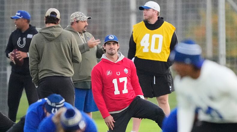 Indianapolis Colts quarterback Daniel Jones (17) stretches during a training session in Berlin, Germany, Friday, Nov. 7, 2025, ahead of Sunday's NFL football game against the Atlanta Falcons. (AP Photo/Martin Meissner)