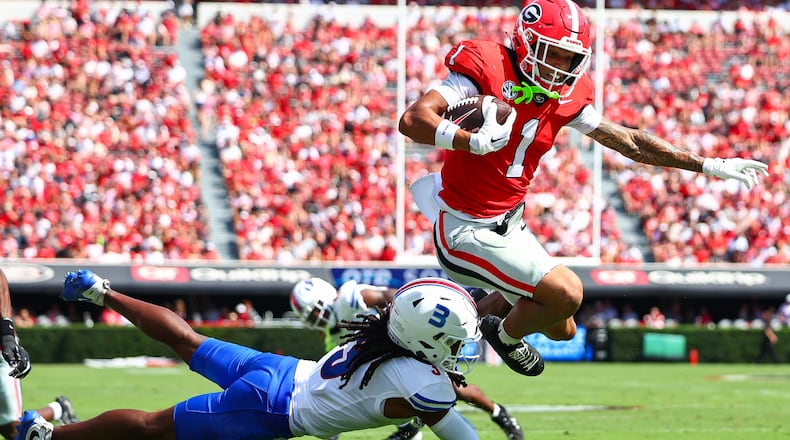 Georgia wide receiver Talyn Taylor (1) hurdles Tennessee State defensive back Mikeece Jones (3) before scoring a touchdown during the first half of an NCAA college football game, Saturday, Sept. 5, 2026, in Athens, Ga. (AP Photo/Colin Hubbard)