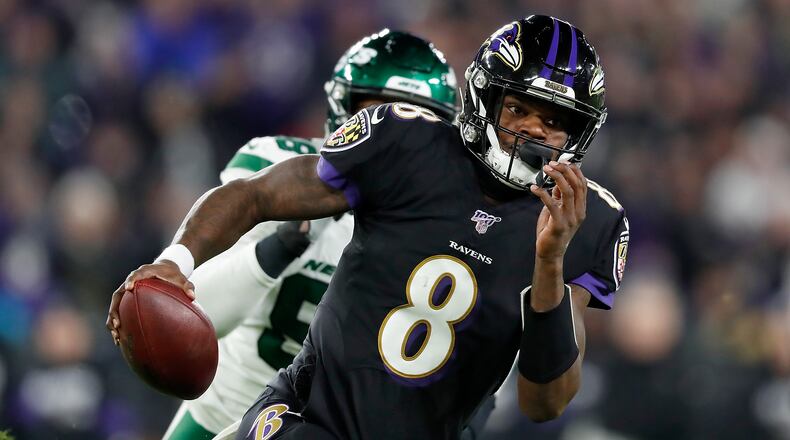 Quarterback Lamar Jackson of the Baltimore Ravens scrambles against the defense of the New York Jets during the game at M&T Bank Stadium on December 12, 2019 in Baltimore, Maryland. (Photo by Scott Taetsch/Getty Images)