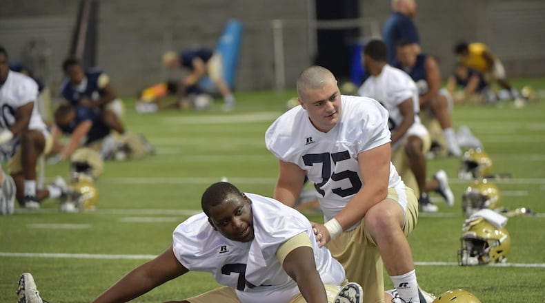 August 4, 2017 Atlanta - Georgia Tech offensive lineman Shamire Devine (71) and offensive lineman Parker Braun (75) warm up during the first day of Georgia Tech football practice at Rose Bowl Field in Georgia Tech campus on Friday, August 4, 2017. HYOSUB SHIN / HSHIN@AJC.COM