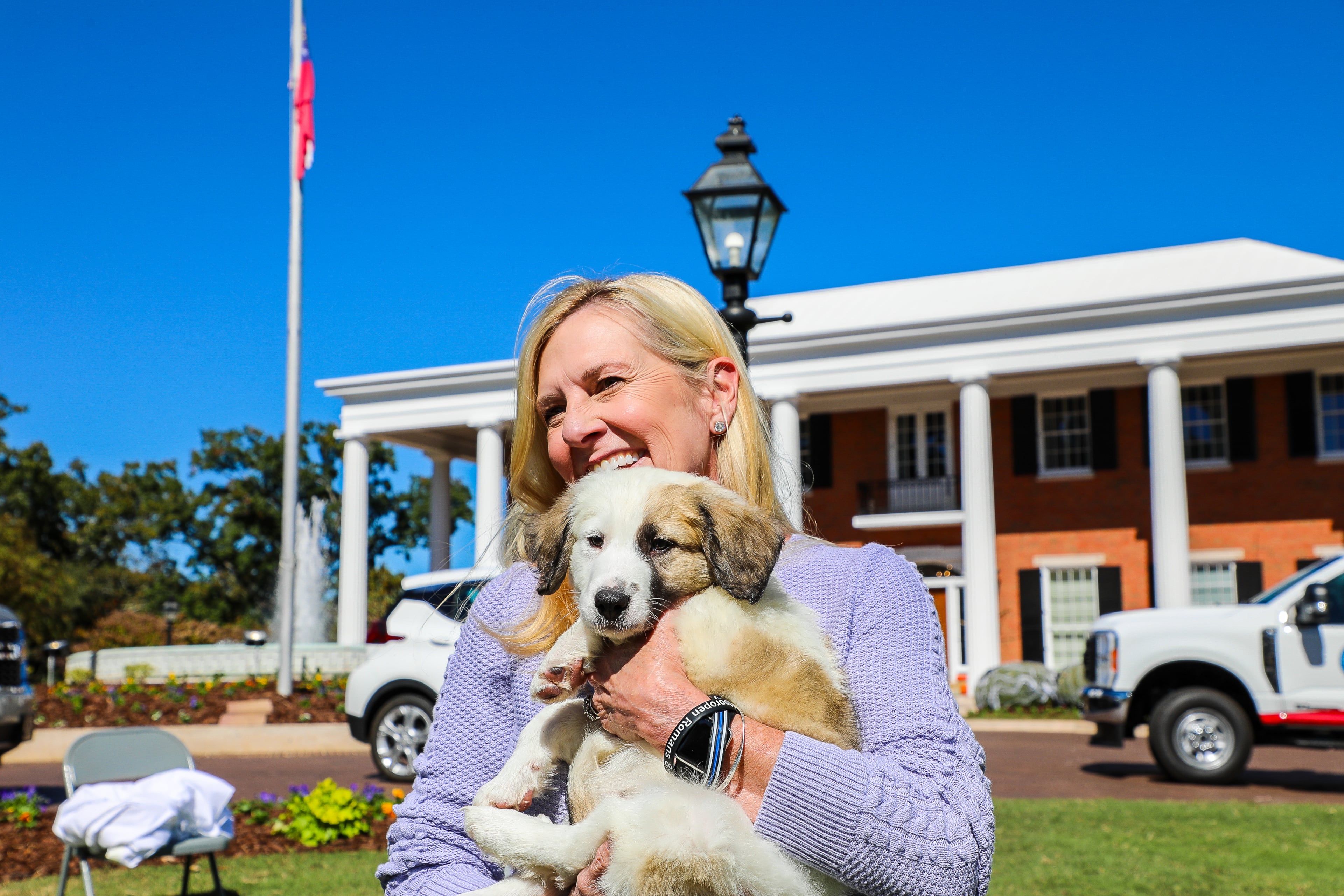 First lady Marty Kemp held a dog during a Pet Adoption Day event at the Governor's Mansion in 2023.