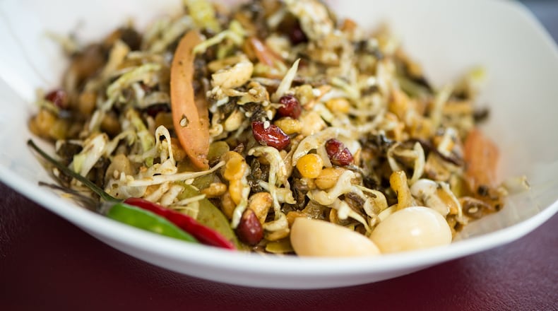 Royal Myanmar Cuisine’s lah pet thoke is a salad made of fermented tea leaves, fried peas, garlic, sesame seeds, lentils, red skin peanuts and tiny threads of cabbage. CONTRIBUTED BY MIA YAKEL