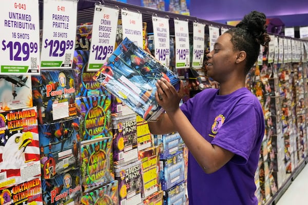 Devoyanna Taylor stocks shelves at a Phantom Fireworks in Youngstown, Ohio Wednesday, June 25, 2025. (AP Photo/Sue Ogrocki)