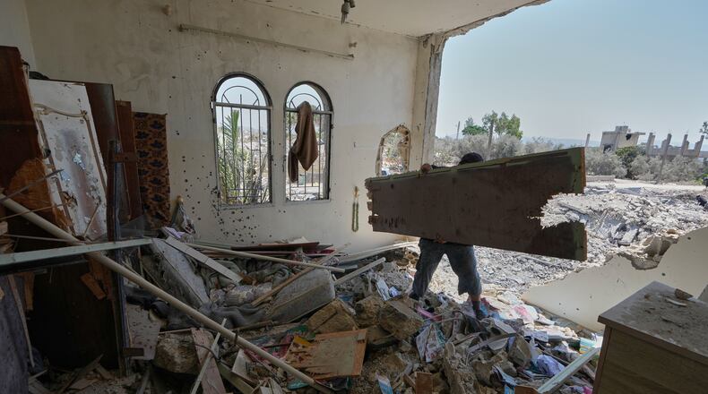 A Lebanese man removes debris from his destroyed house in the village of Zawtar al-Gharbieh, south Lebanon, Wednesday, Aug. 5, 2026. (AP Photo/Mohammed Zaatari)