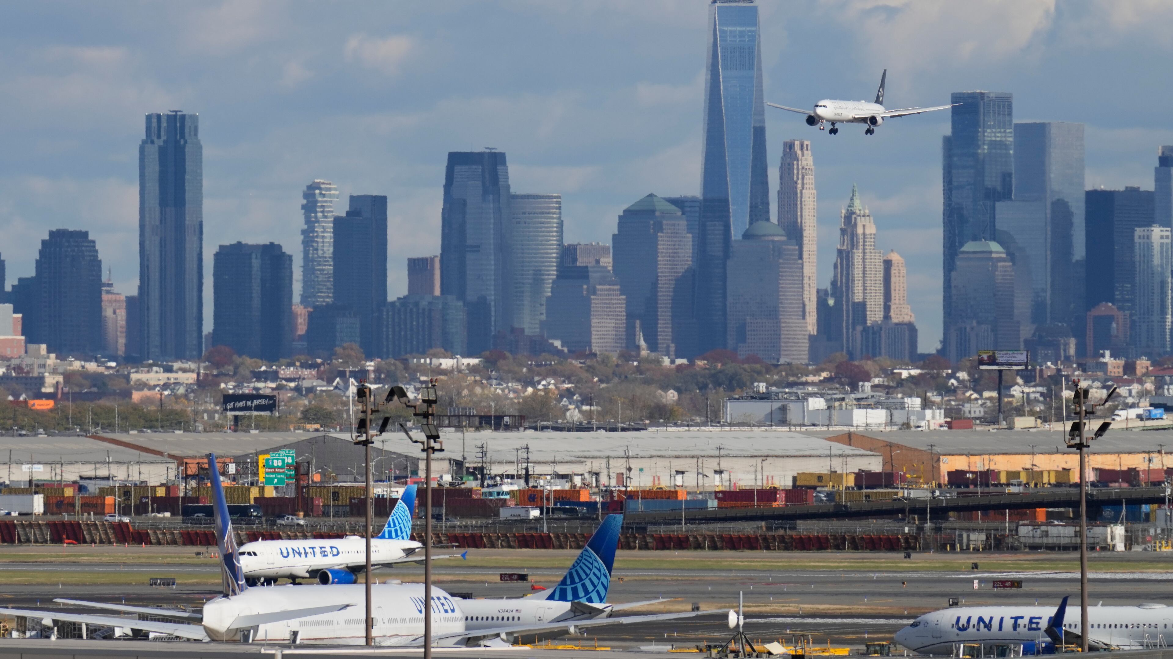 The New York City skyline is seen behind a plane approaching Newark International Airport in Newark, N.J., Thursday, Nov. 6, 2025. (AP Photo/Seth Wenig)