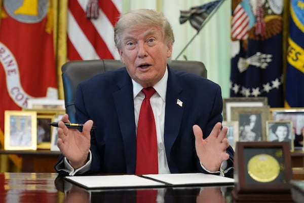 President Donald Trump signs a presidential memo to the Environmental Protection Agency in the Oval Office of the White House last month. (Jacquelyn Martin/AP)