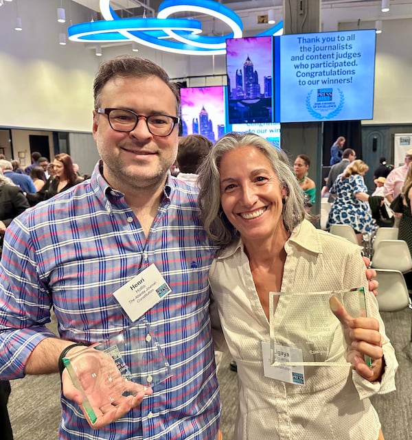 AJC restaurant critic Henri Hollis and former senior Food & Dining editor Ligaya Figueras show off their Atlanta Press Club Awards of Excellence.