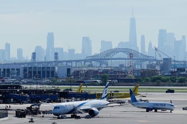 The New York City skyline is seen behind Newark Liberty International Airport in Newark, N.J., Wednesday, May 7, 2025. (AP Photo/Seth Wenig)