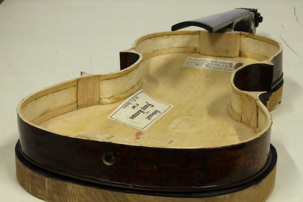 Tags from its maker are seen inside a Dachau-built instrument dubbed the ''violin of hope'', in Magyarpolány, Hungary, Tuesday September 8, 2020. (Szandra Katona via AP)