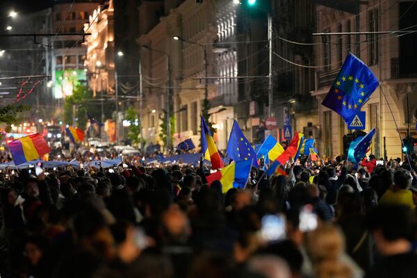 Supporters of Presidential candidate Nicusor Dan celebrate on the street after polls closed for the second round of the country's presidential election redo in Bucharest, Romania, Sunday, May 18, 2025. (AP Photo/Vadim Ghirda)