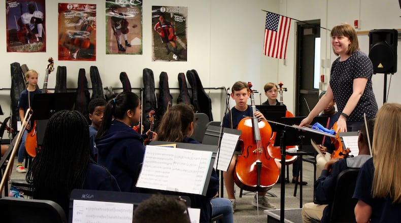 Christine Esposito leads students in an orchestra class at Marietta Schools’ Sixth Grade Academy. This was the first year the school offered strings as a course. CONTRIBUTED