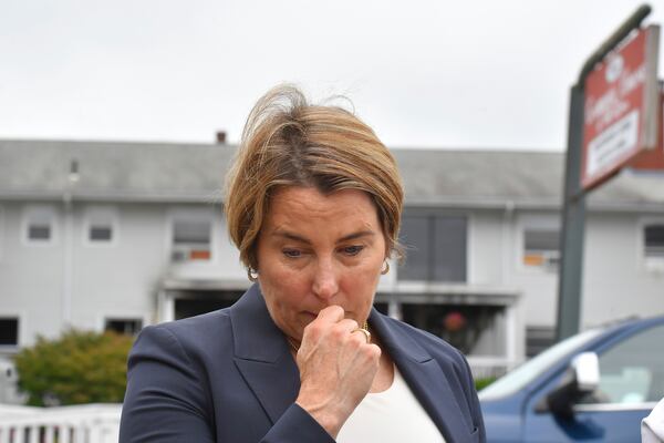 Massachusetts Gov. Maura Healey approaches a news conference to face reporters Monday, July 14, 2025, near the Gabriel House assisted living facility, behind, following a fire that started late Sunday in Fall River, Mass. (AP Photo/Steven Senne)