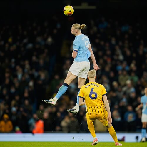 Manchester City's Erling Haaland, top, heads the ball past Brighton's Jan Paul van Hecke during the English Premier League soccer match between Manchester City and Brighton and Hove Albion in Manchester, England, Wednesday, Jan. 7, 2026. (AP Photo/Dave Thompson)
