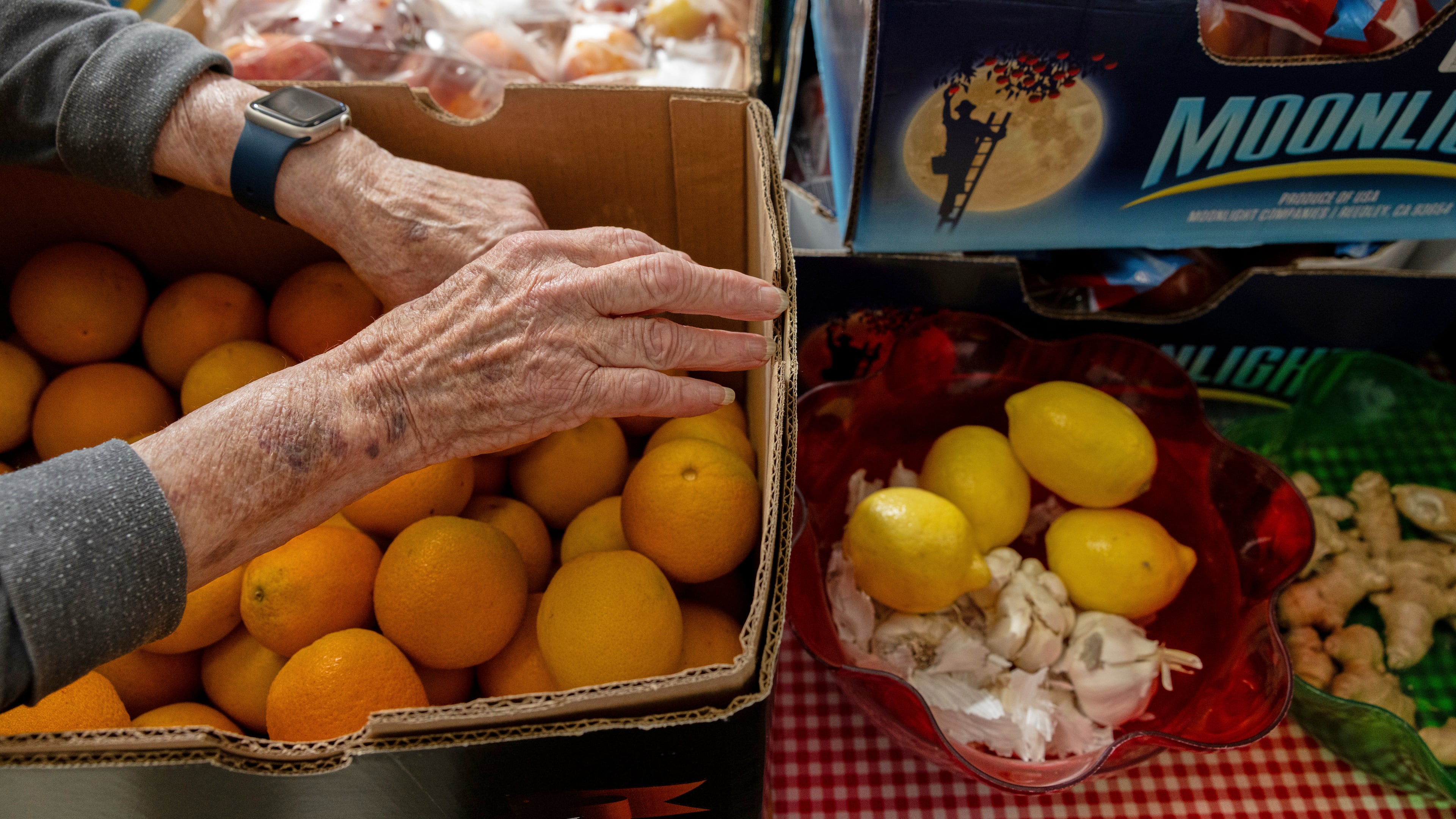 On Tuesdays, volunteers at Neighbor's Cupboard unload boxes of dry goods and sort fresh produce in Winterport, Maine, on Aug. 26, 2025. (Katherine Emery/The Maine Monitor via AP)