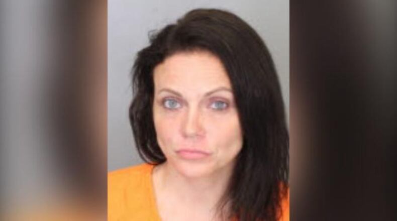 Dana Vela, 33, of Cordova, Tennessee, is accused of punching a police officer in the face and yelling racial slurs at him after being arrested Sunday.