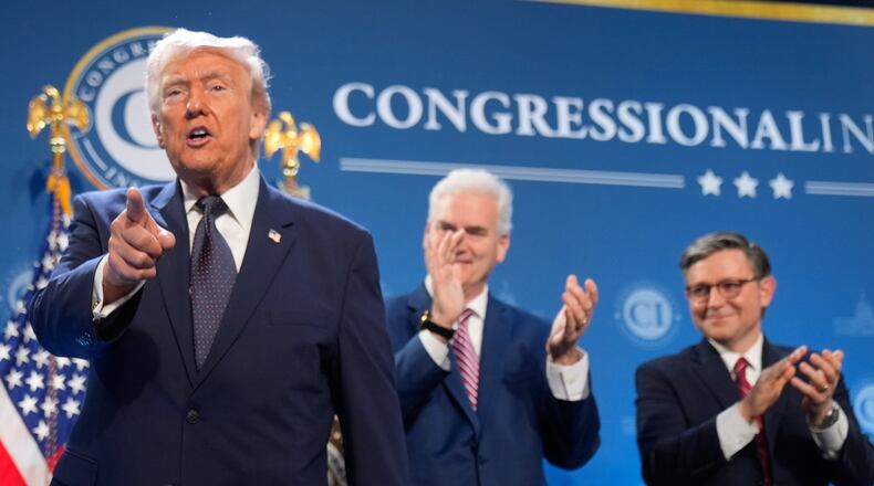 President Donald Trump gestures as Rep. Tom Emmer, R-Minn., and House Speaker Mike Johnson of La., applaud at the Republican Members Issues Conference, Monday, March 9, 2026, at Trump National Doral Miami in Doral, Fla. (AP Photo/Mark Schiefelbein)